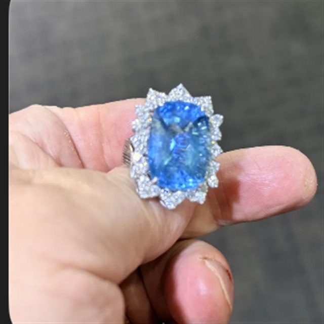 Blue topaz and diamond halo cocktail ring in 18k white gold