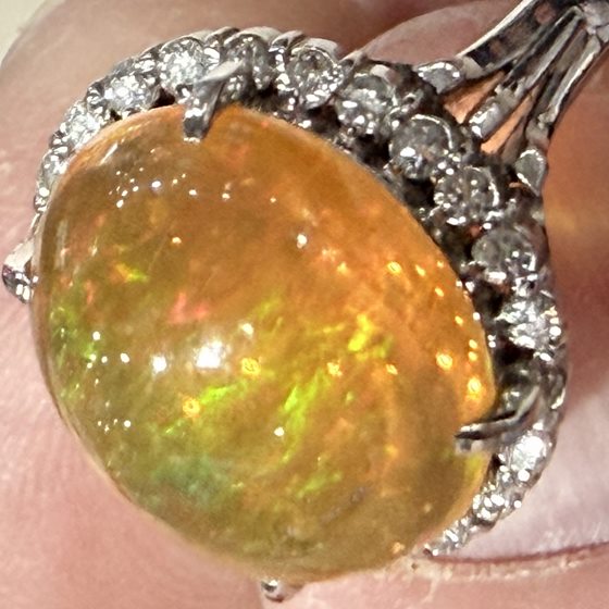 Platinum estate ring with 5.08ct opal cabochon and diamond halo